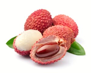 Sweet lychees fruits with leaves close up on white background .